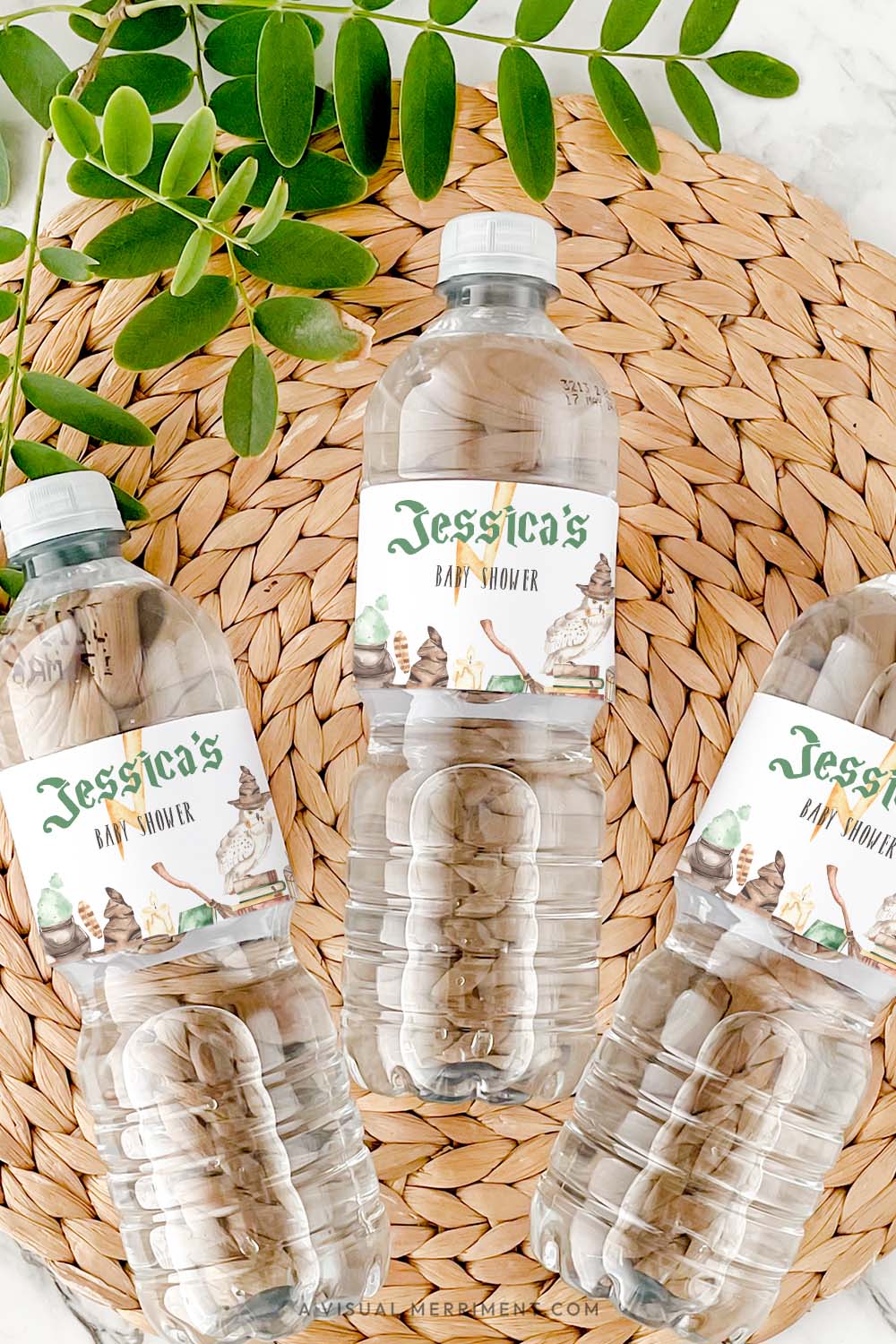 Vertical of bottles with harry potter style baby shower water bottle labels in magical elements on grass mat 