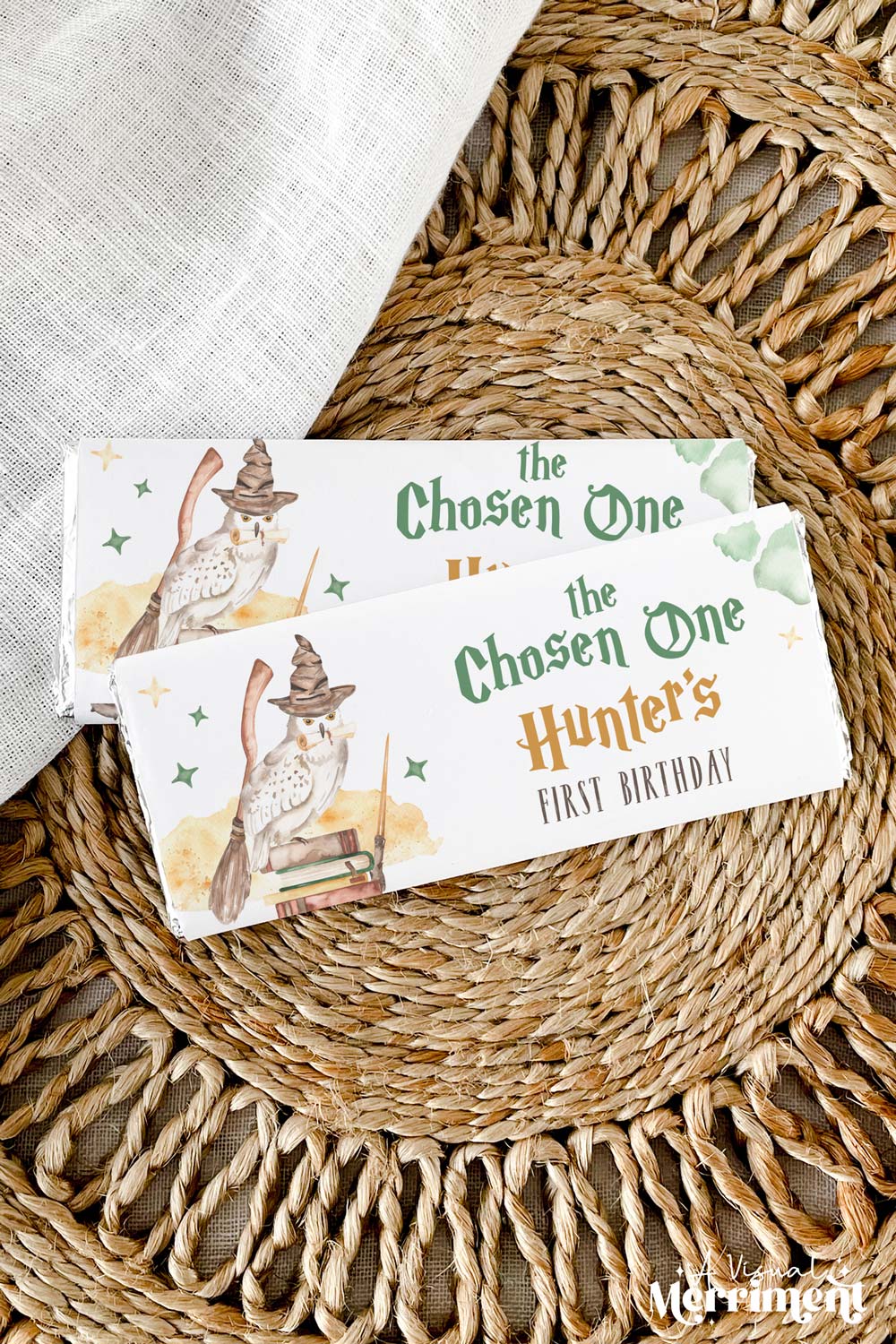 Vertical of chocolate wrappers on candy with harry potter style chosen one magic school design on a woven mat