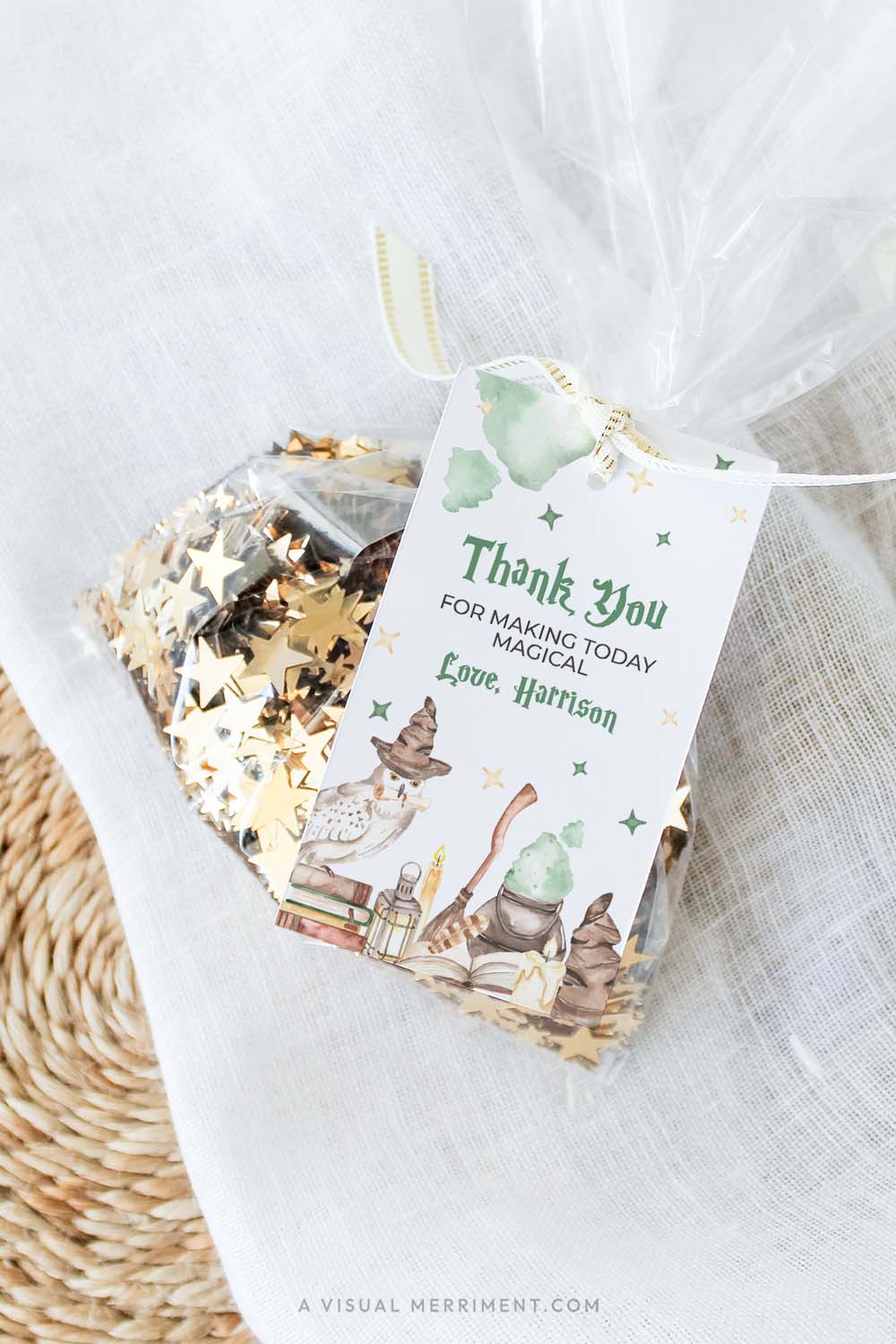 vertical of Harry potter style printable gift tag template with wizard school elements attached to bag of sequins
