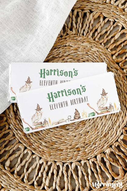 Vertical of chocolate wrappers on candy with harry potter style magic school design laid on a woven mat